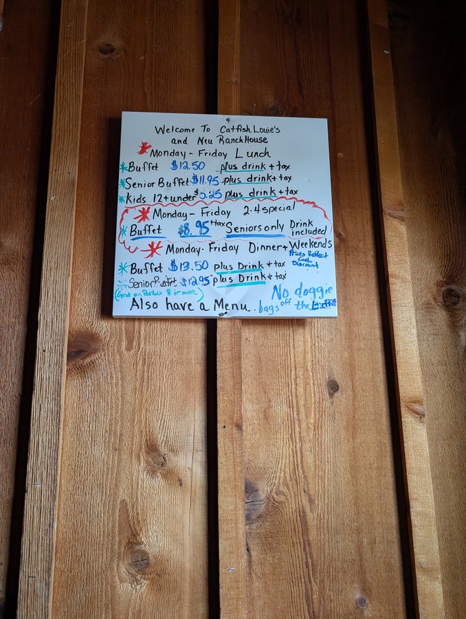 The hand-written buffet price board at Catfish Louie's and Neu Ranch House.