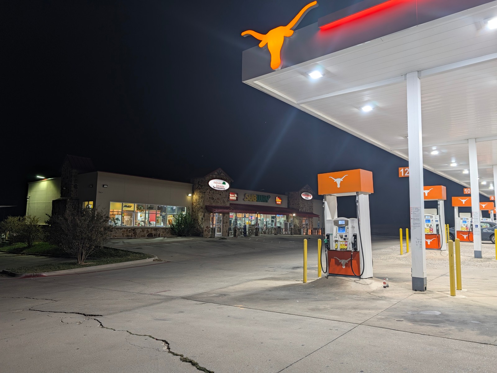 The fuel pumps and canopy at the 82 Travel Center after dark.