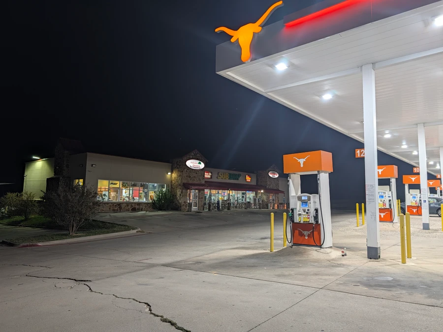 The fuel pumps and canopy at the 82 Travel Center after dark.
