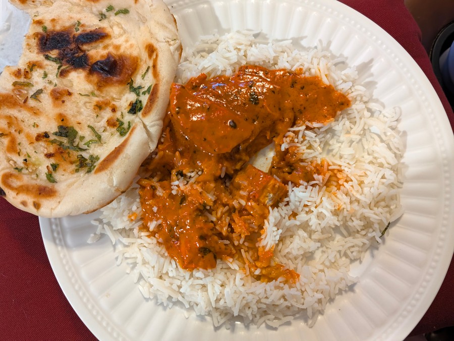 Butter chicken over rice with garlic naan from Indian Dhaba.