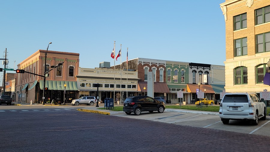 Flags and storefronts around the downtown Gainesville square, April 2021.
