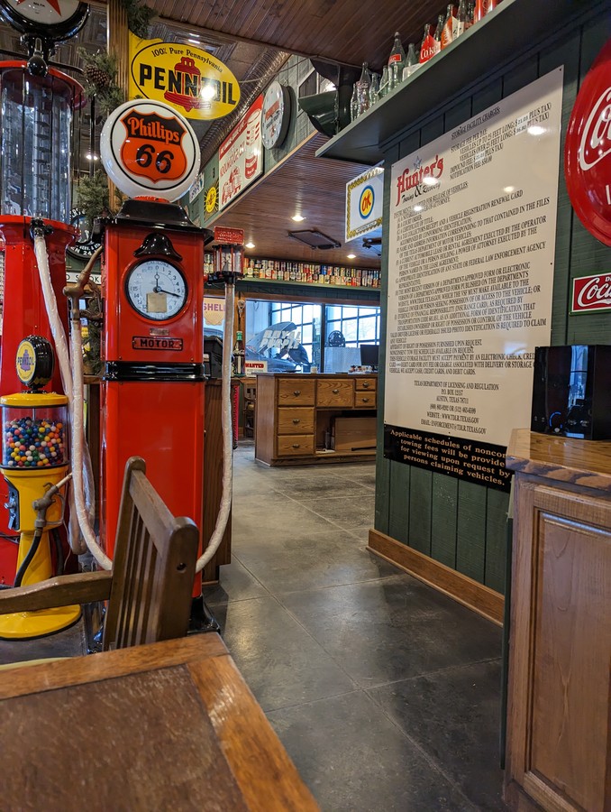 The vehicle-release notice board and vintage pump decor in the Hunter's Towing & Recovery lobby.