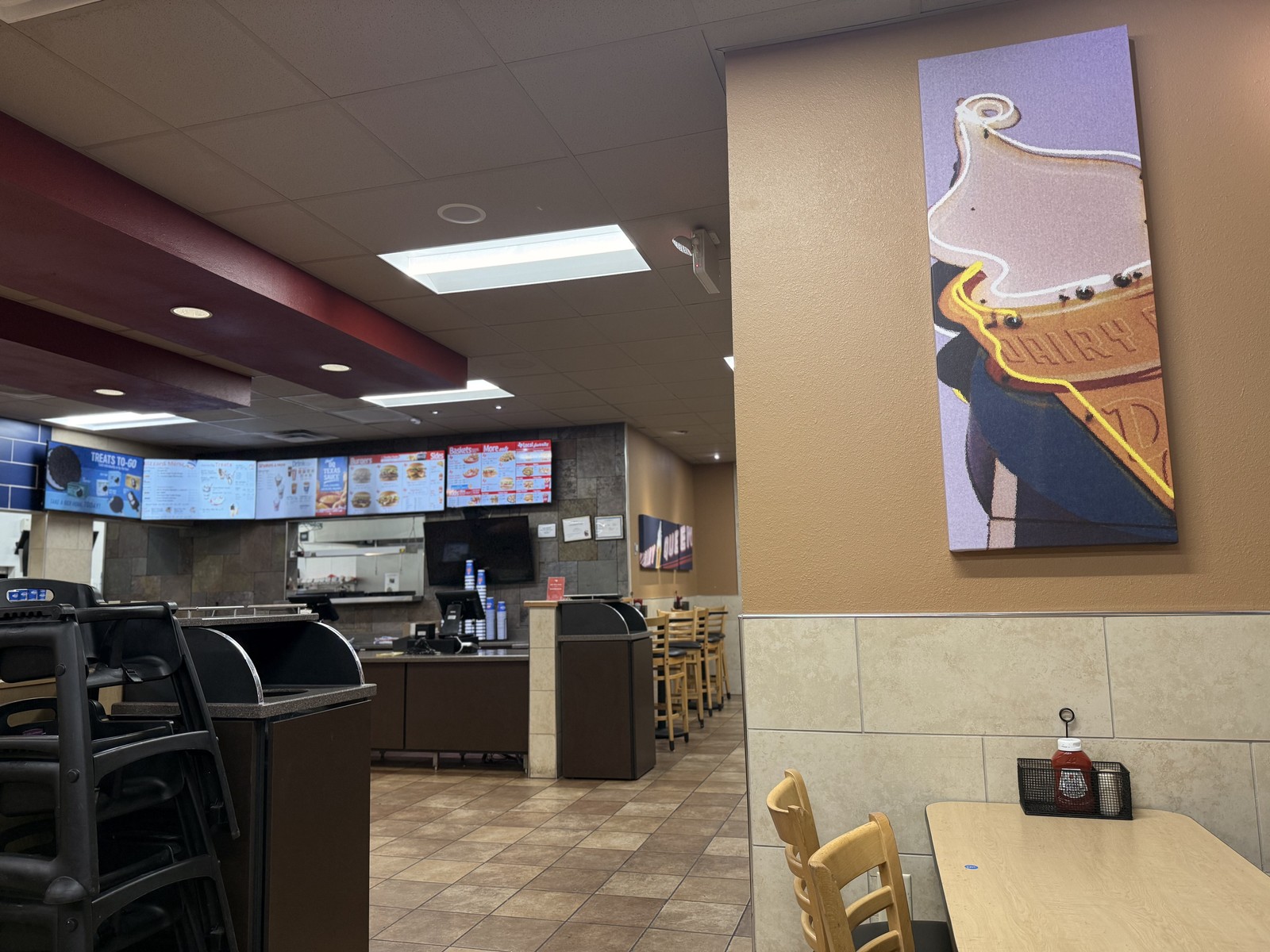 The dining room seen from the side, from the soft-serve art on the wall to the order counter.