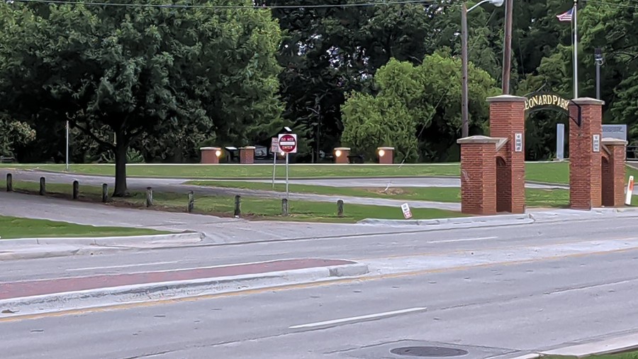 The brick gateposts of Leonard Park from across West California Street on a cloudy evening.