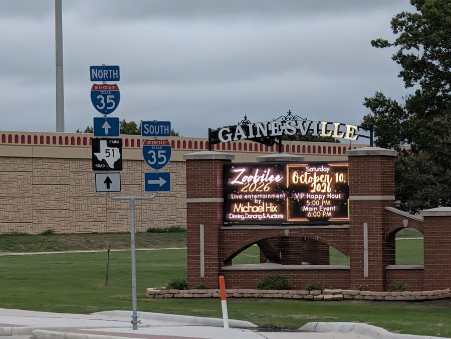I-35 North and South shields and a Texas farm-road marker in front of the lit Gainesville marquee.