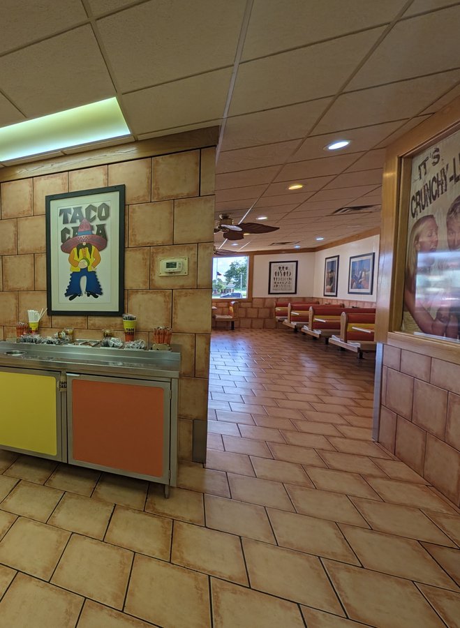 Taco Casa art hangs over the salsa bar, and red booths line the windows of the dining room.